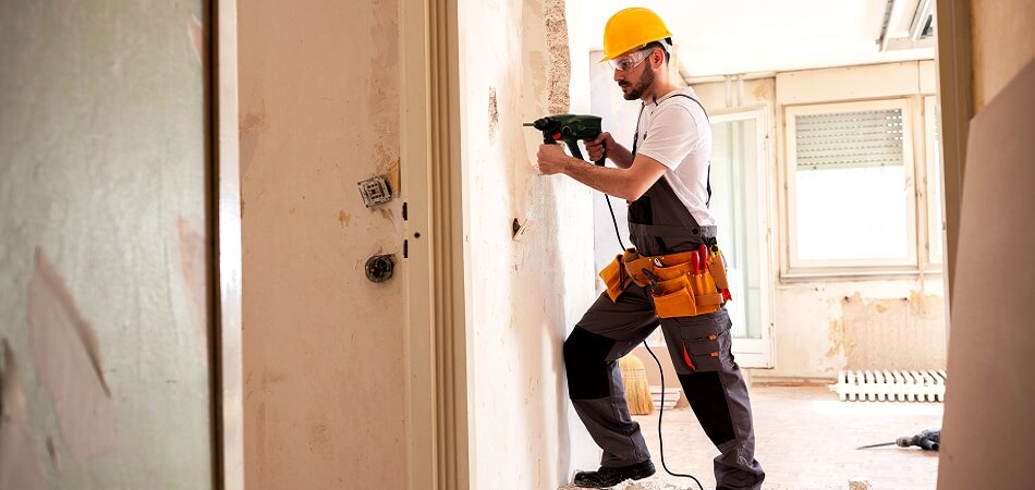 Experienced Worker Using Hammer Drill